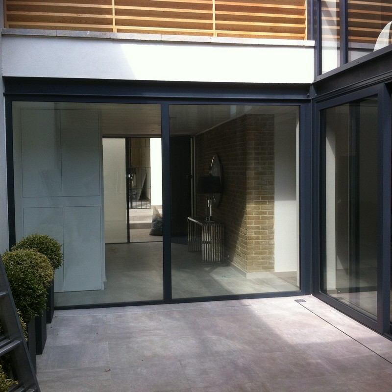 Floor-to-ceiling sliding doors opening to courtyard in Newbury